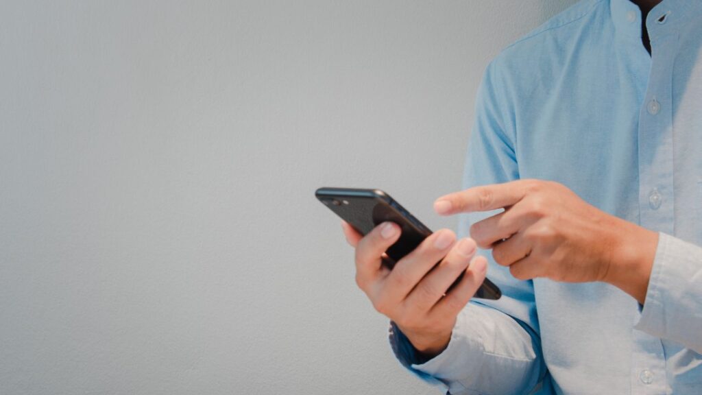 Man confidently talking on phone with checklist for loan approval – Vizzve Finance