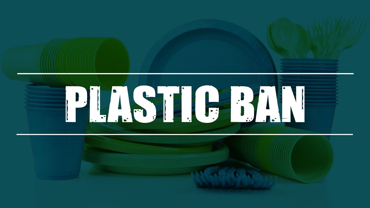 Indian family using jute bags and steel bottles during grocery shopping with "Plastic Ban 2.0" poster in background.