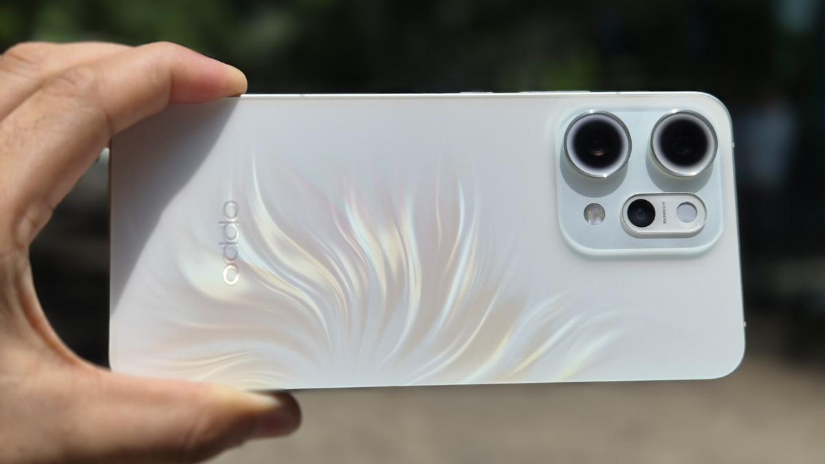 Oppo Reno 14 Pro smartphone in hand showing sleek design and camera setup