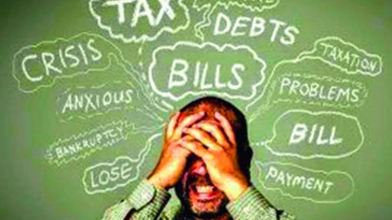 Indian man stressed about monthly EMI payments with calculator