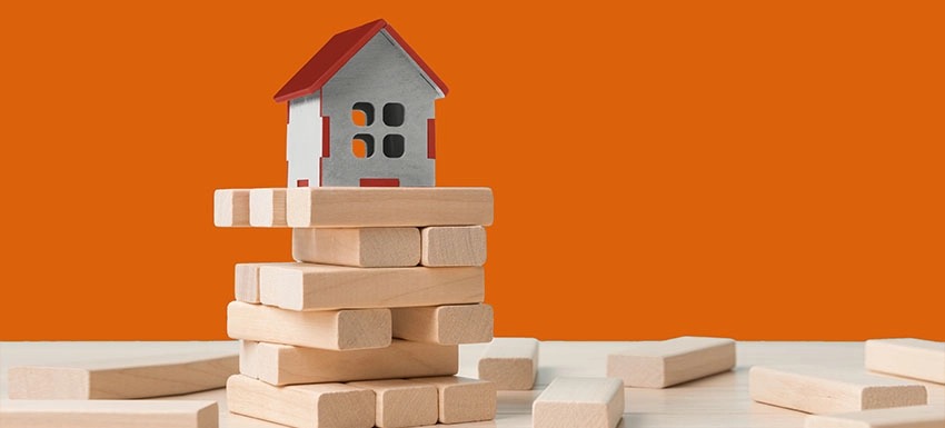 Construction site with blueprint and a family holding a home loan approval document