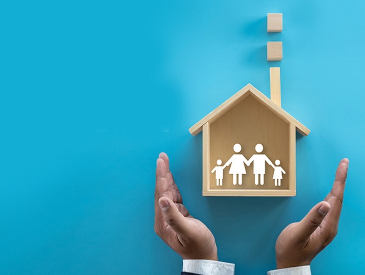 Indian family looking at blueprints for home extension with a builder on-site