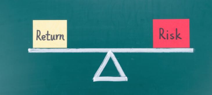 Young Indian investor comparing high-risk and low-risk investment charts on laptop