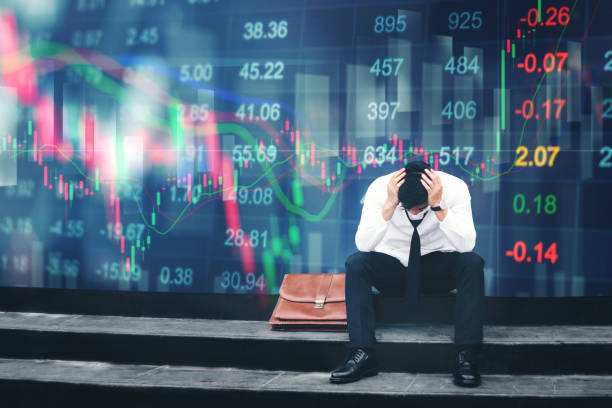 Stressed investor looking at stock market crash chart with emotional graph overlay