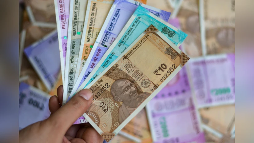 Trader monitoring currency charts as Indian Rupee strengthens against a declining US dollar in July 2025