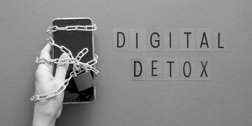 An Indian millennial relaxing in nature, phone turned off, with text overlay: “Digital Detox, Real Savings – Vizzve Finance x Lifestyle Series”.