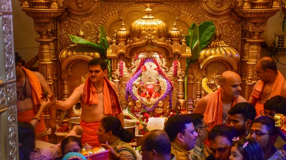 Devotees dressed in traditional Indian attire inside Siddhivinayak Temple, adhering to the new dress code banning shorts and revealing clothing