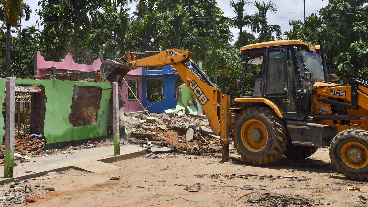 Assam government eviction drive underway with police and bulldozers clearing encroached land from forest area