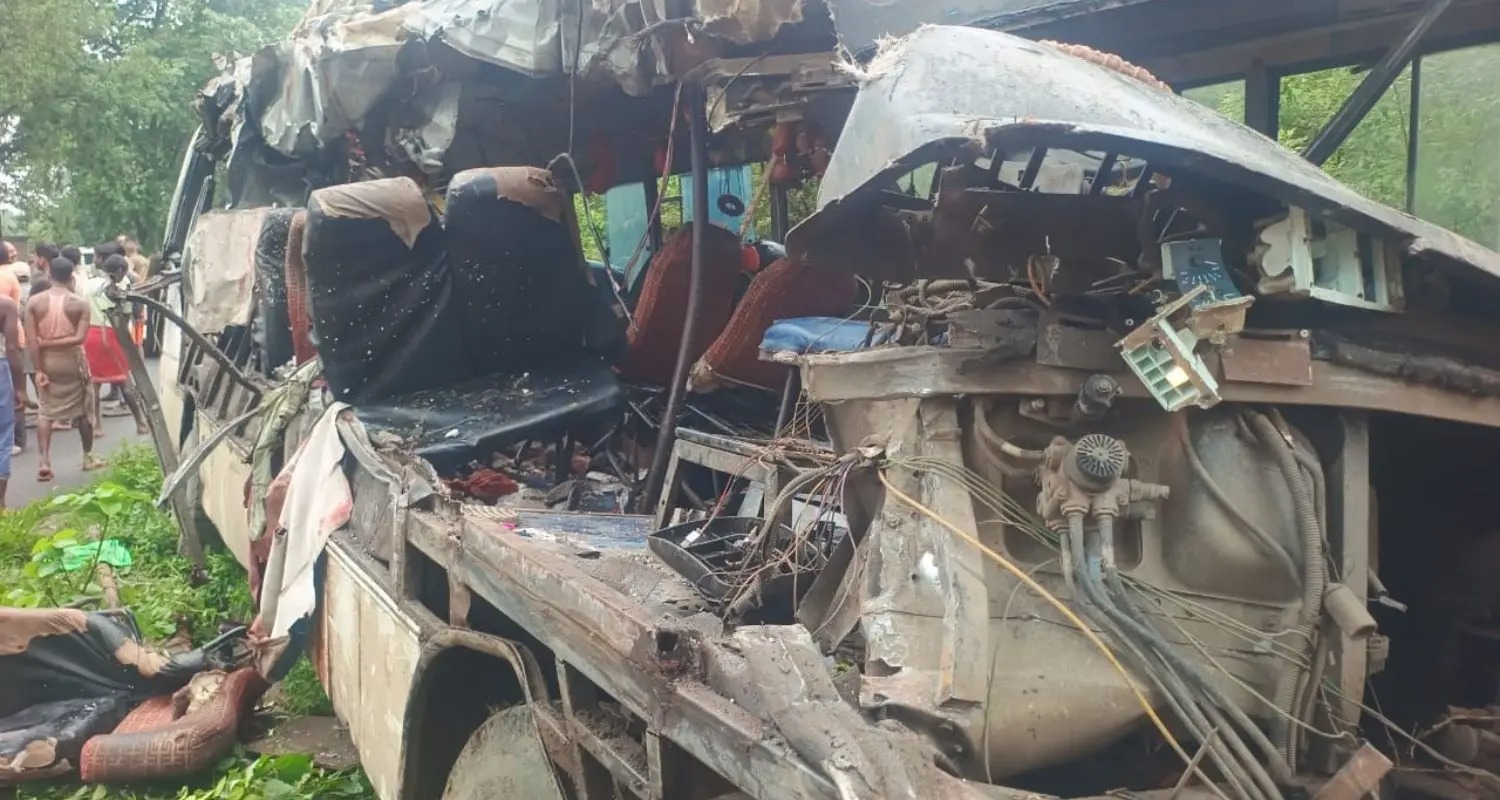 Scene of Deoghar road accident showing overturned bus and police rescue team assisting injured Kanwariya pilgrims