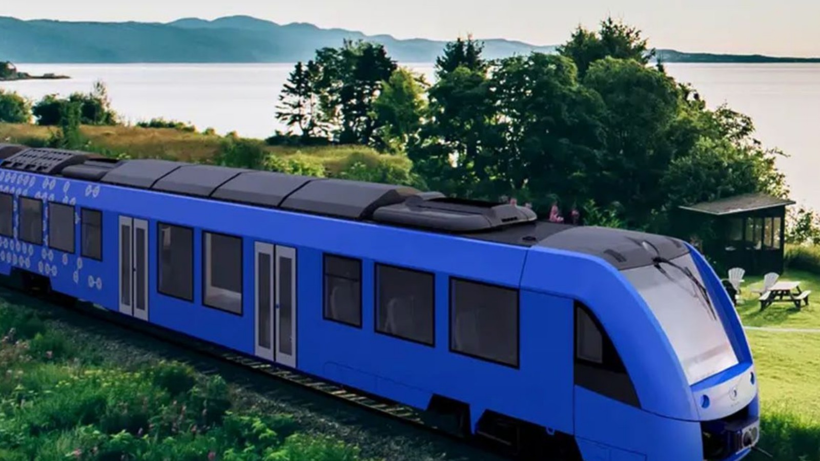 India’s first hydrogen-powered railway coach parked on a trial track with green energy symbols and Indian Railways logo