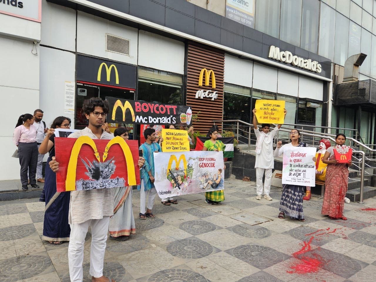 Protesters holding Shut McDonald's posters during Operation Sindoor debate in India