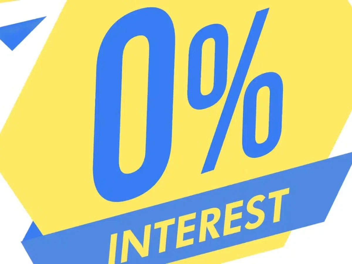 A magnifying glass over a “0% Interest” label revealing hidden charges