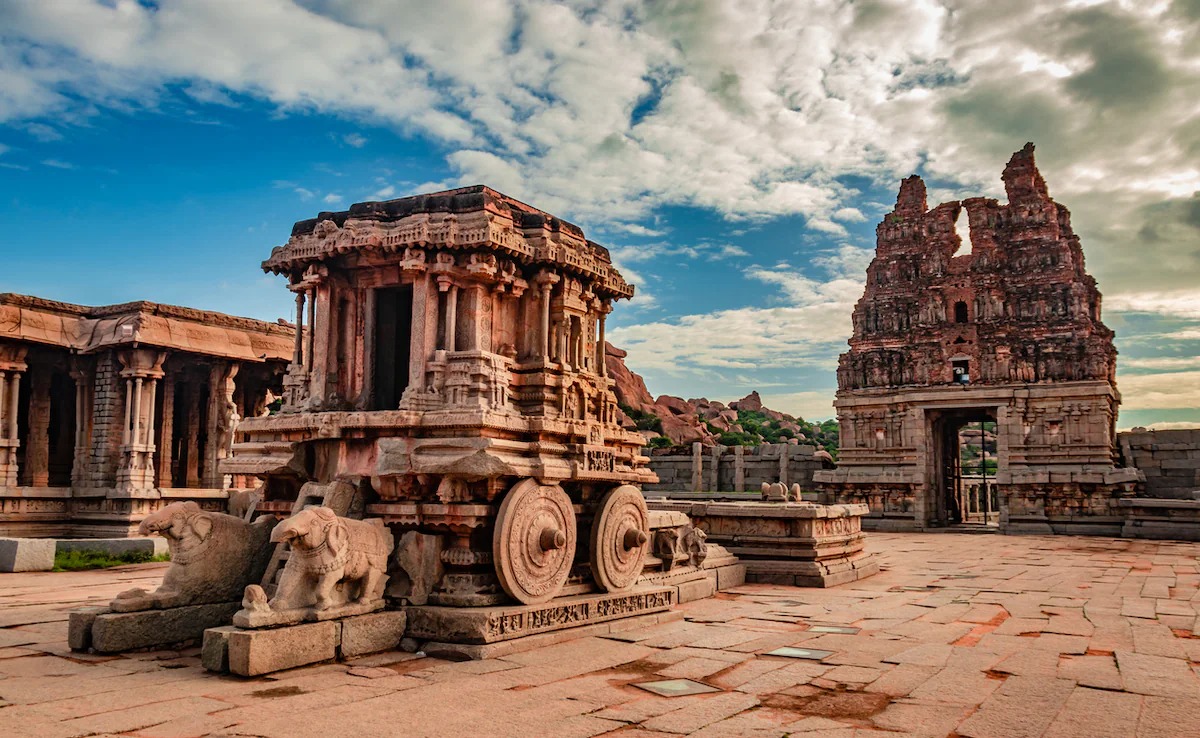 Ancient temple street in India with traditional architecture and people in traditional dress