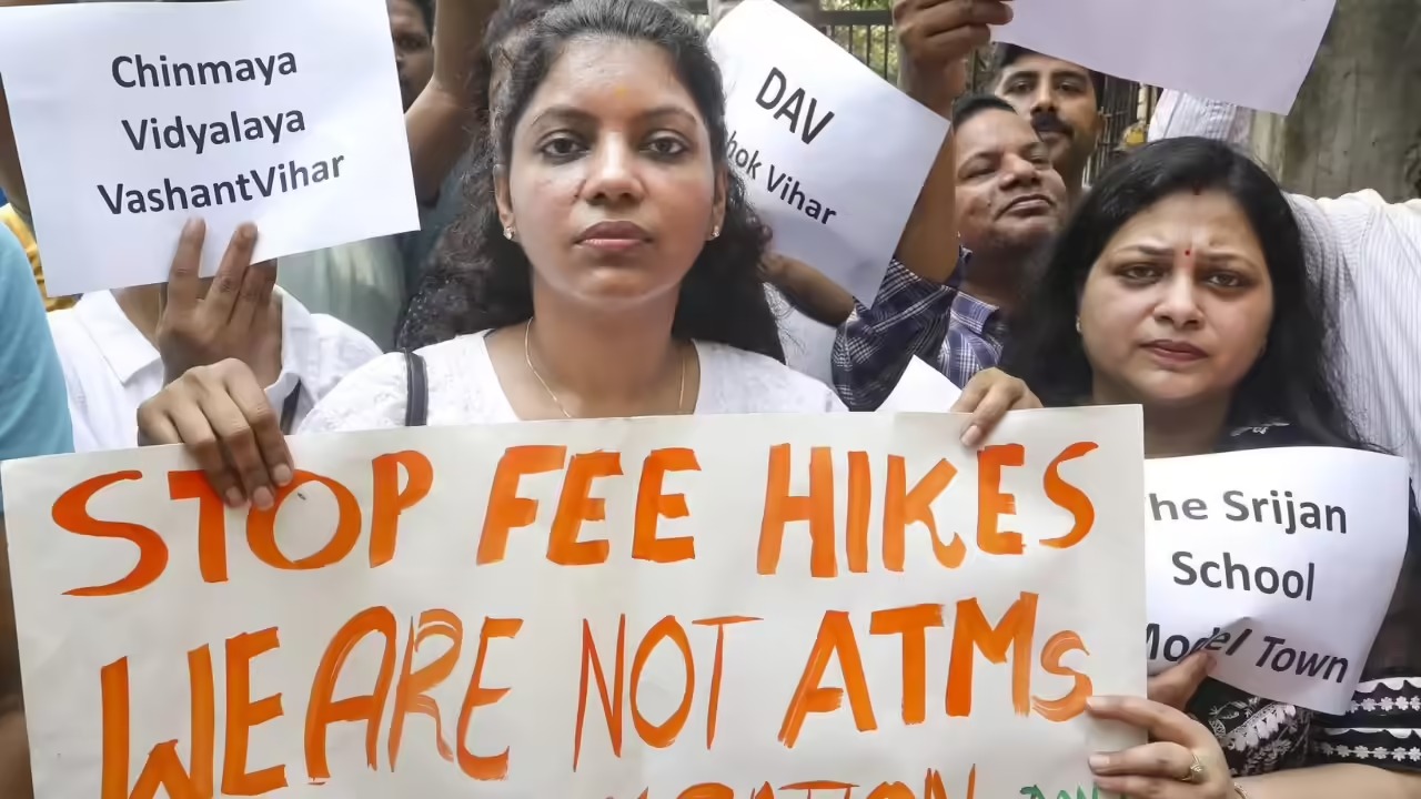 Parents protesting against private school fees in Delhi with government posters in background