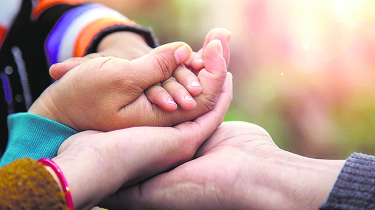 Mother and infant bonding by the sea, representing nurturing care during the crucial first 1,000 days of life