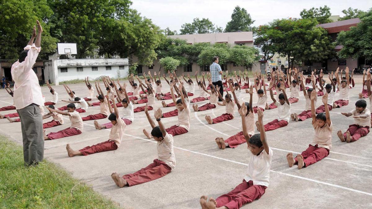 Students doing yoga and exercises from Tamil Nadu’s new PE textbooks in a classroom setting