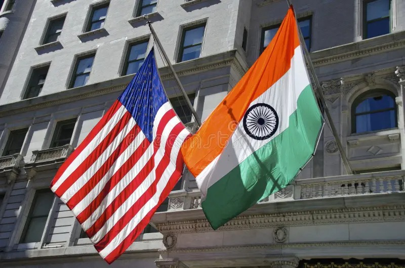 Flags of India and the US facing each other, symbolizing trade conflict