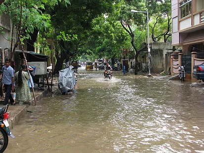 Kanpur school gate closed with heavy rain and puddles outside