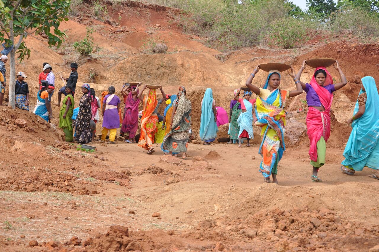 MGNREGA work site in rural Bengal with rain warning sign