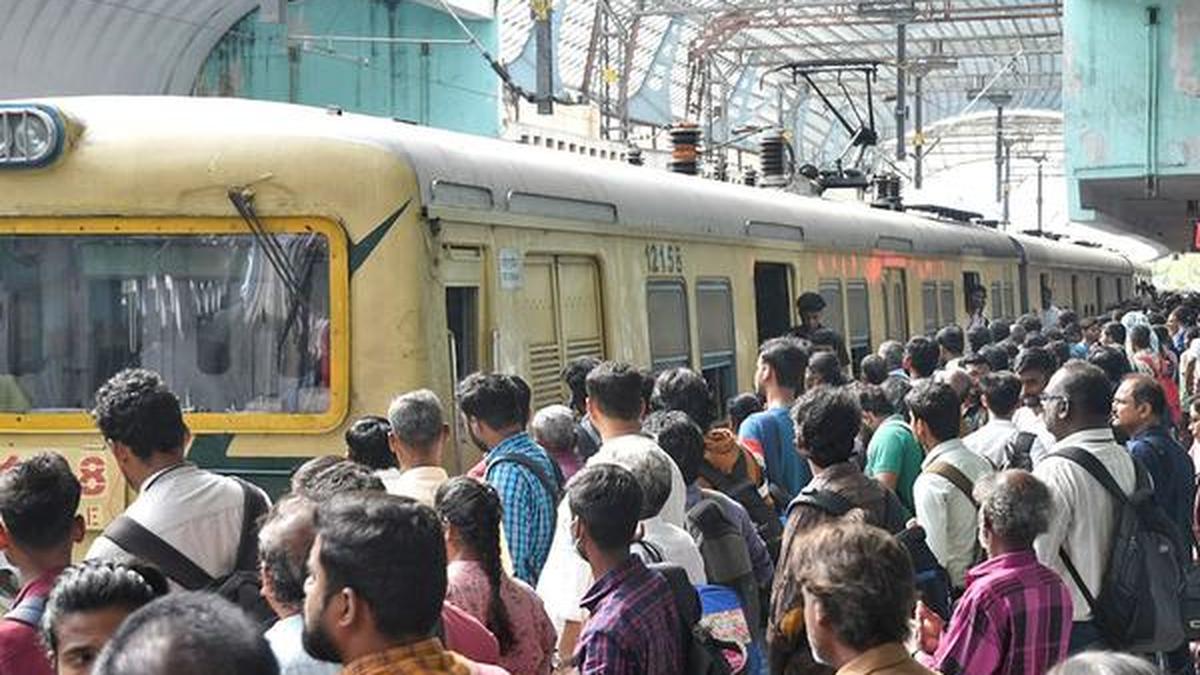 Chennai Metro rail train arriving at an MRTS elevated station undergoing renovation and upgrade