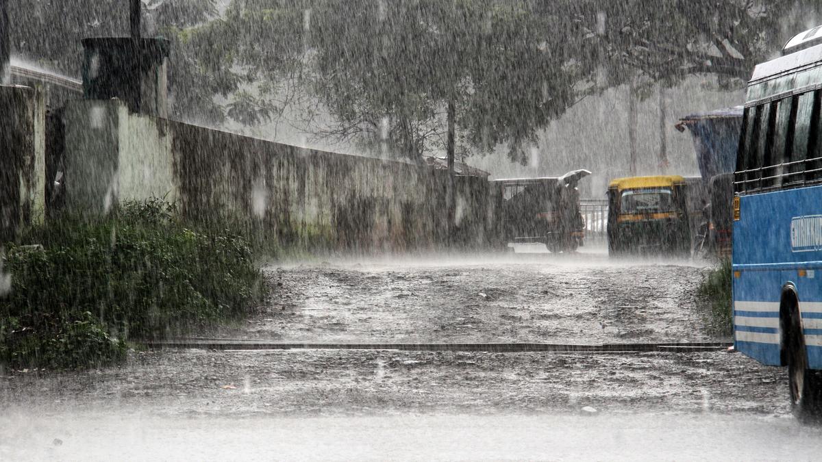 Collapsed gypsum board ceiling debris scattered inside a school auditorium hall in Kerala during a rain holiday