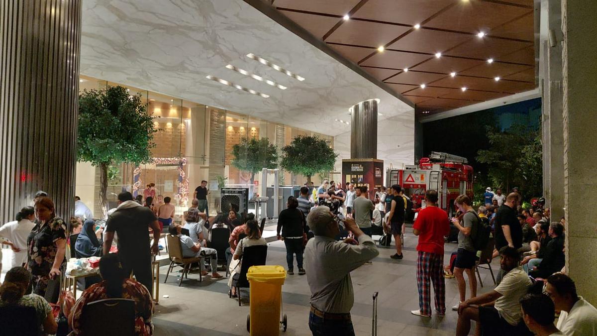 Smoke and emergency lights outside a star hotel in Chennai during an evacuation caused by a late-night fire incident