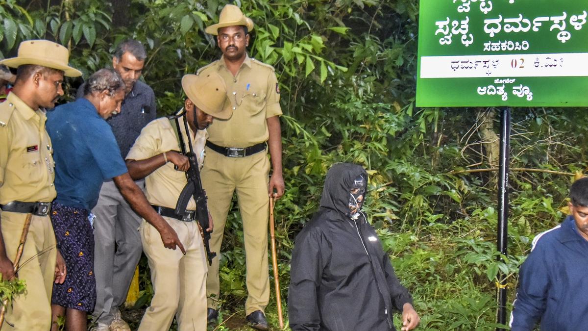 Law enforcement officials and SIT investigators conducting forensic site search in Dharmasthala village amid police misconduct allegations