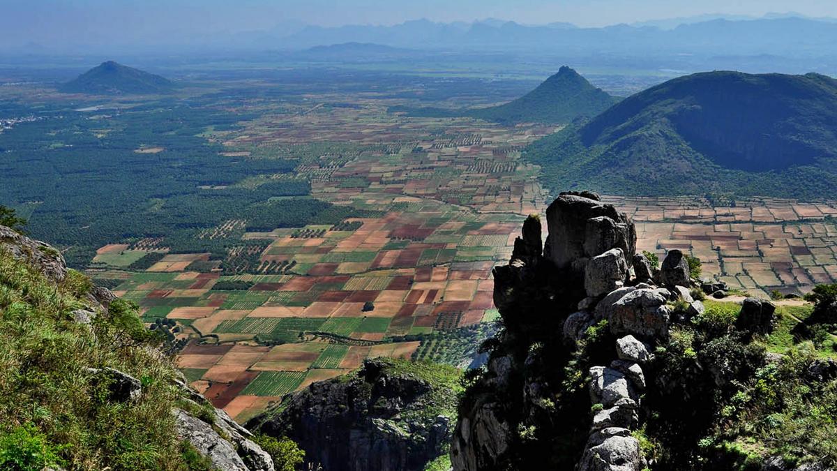 Scenic panoramic view of Ramakkalmedu hill station with wind farms and Kuravan Kurathi statue, highlighting plans for tourism infrastructure upgrades