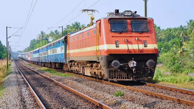 Interior of Indian train coach with visible CCTV camera installed above seats