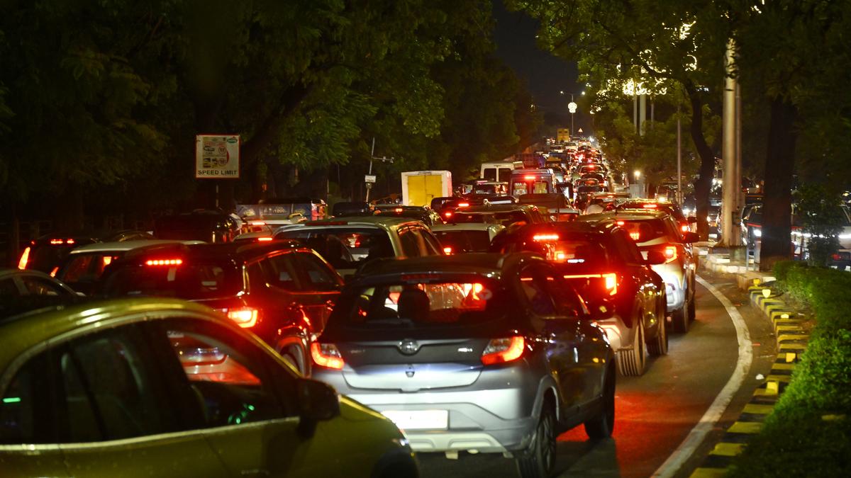 Traffic congestion and road construction in Hyderabad with a digital map overlay showing live traffic data discrepancies
