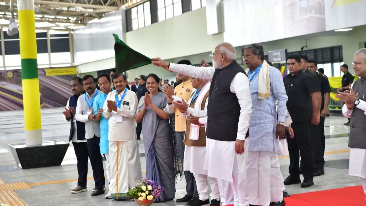 Bengaluru Metro Yellow Line train at a station with passengers boarding