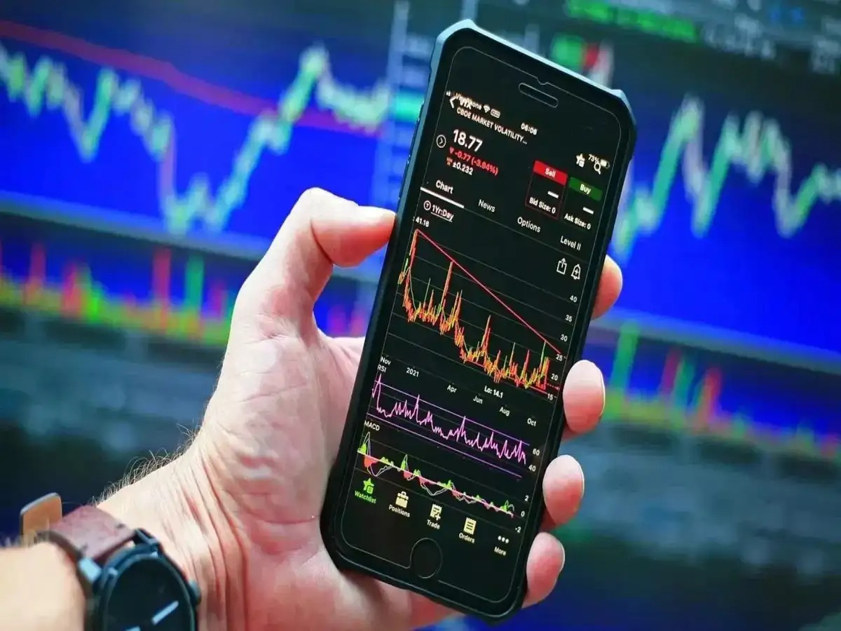 Investor monitoring Sensex fall on laptop and mobile app