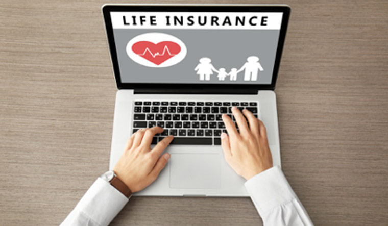 Comparing insurance policies online on a laptop in India