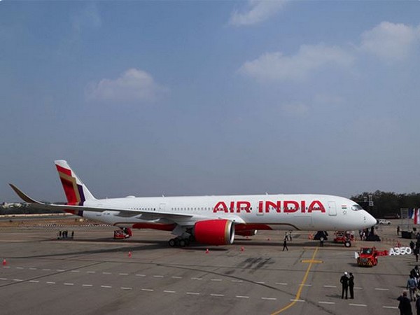 Air India aircraft on the runway at Delhi airport, grounded for inspection after a fire indication in the engine.