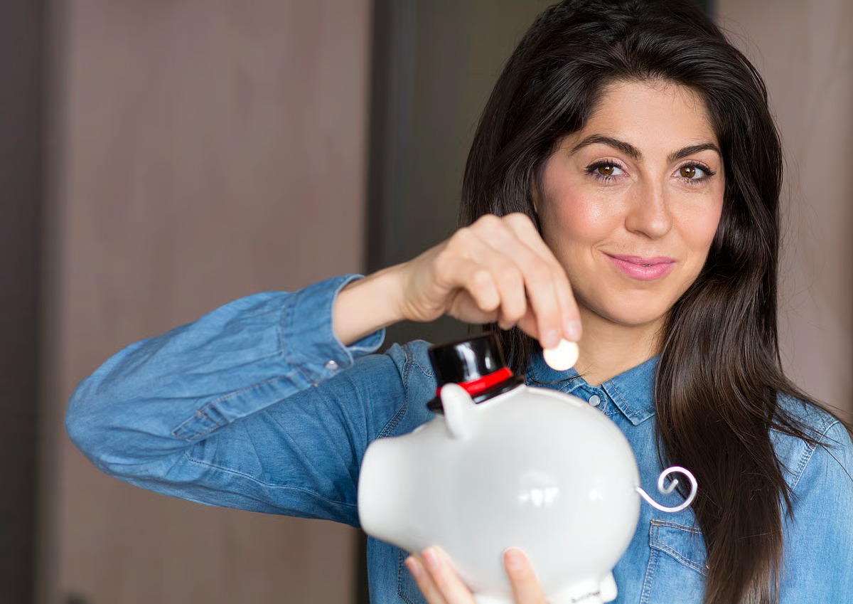 Confident Indian woman holding documents and keys, symbolizing financial empowerment through special loan schemes.