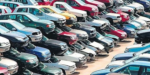 Car dealership lot with unsold vehicles, symbolizing slowdown in auto sales ahead of GST rate cuts.