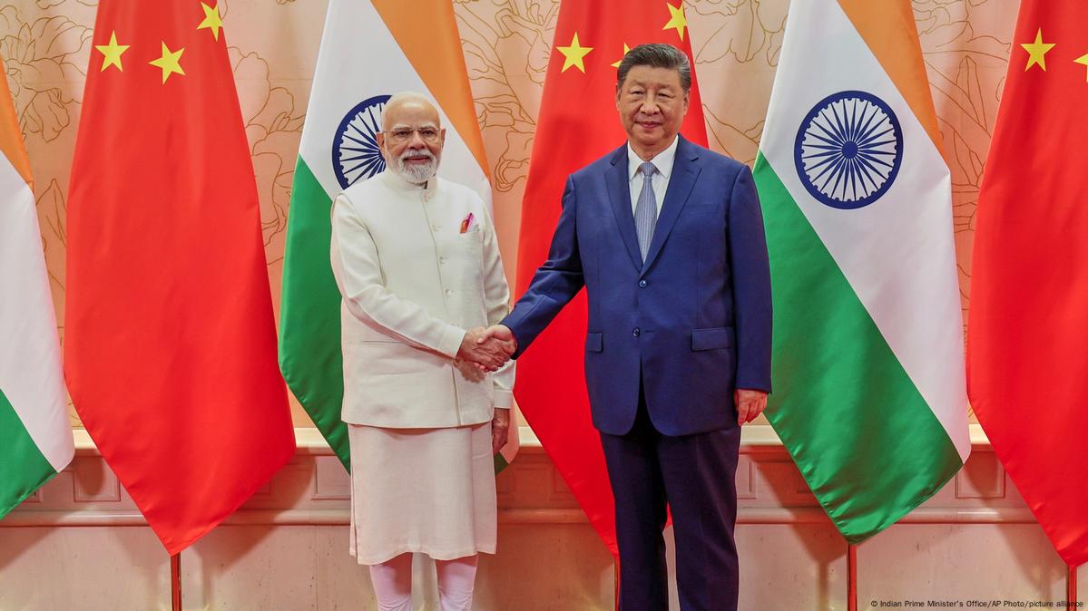 Leaders of India and China shaking hands during the SCO Summit 2025 in a formal diplomatic setting.