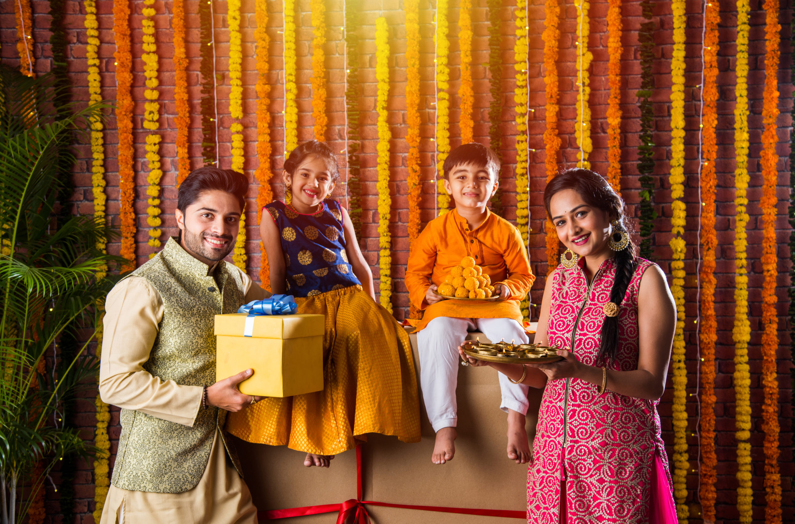 Family celebrating Diwali with lights, sweets, and gifts funded by an instant personal loan