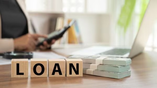 Person calculating personal loan EMI on a laptop in September 2025