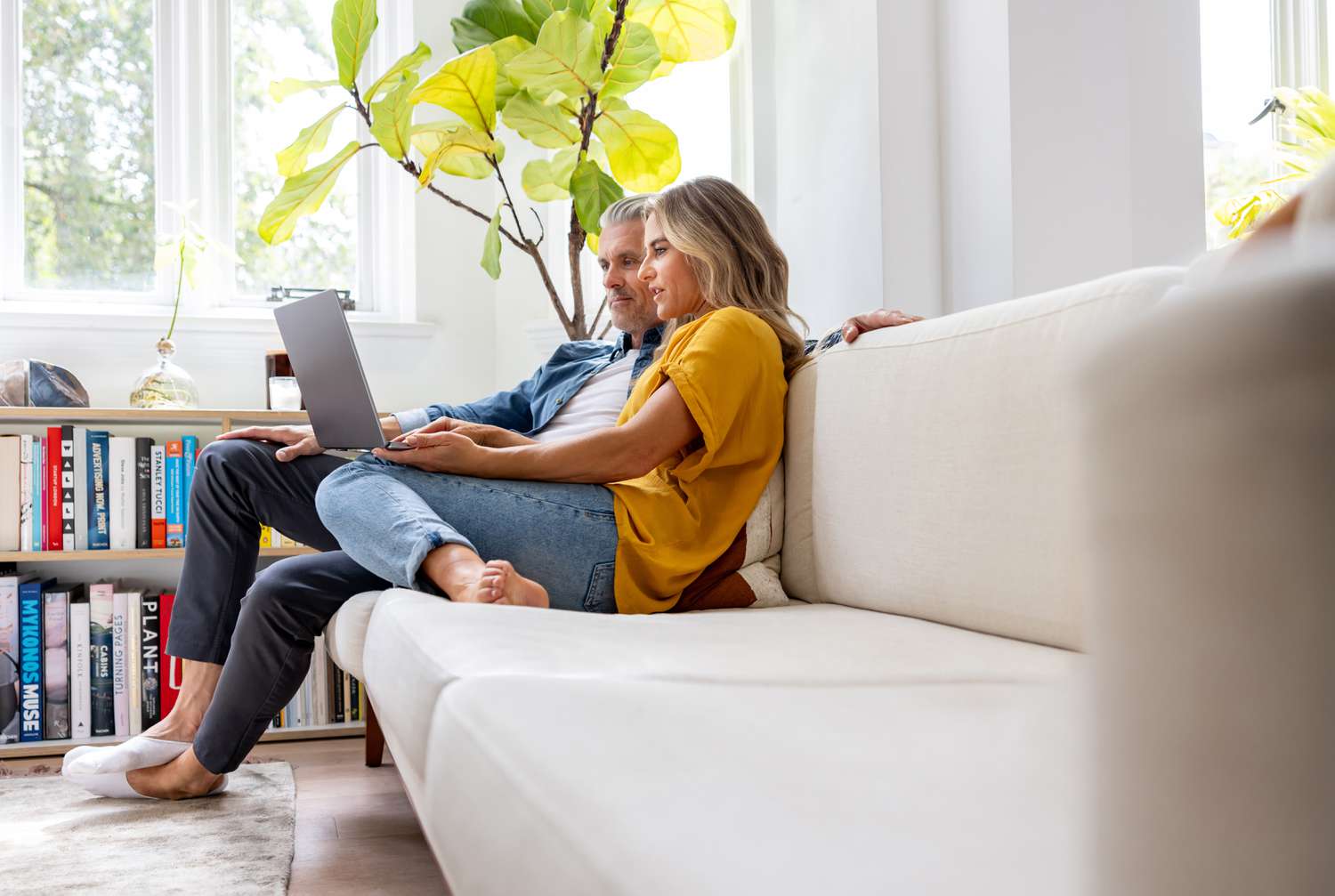 Couple reviewing home loan options on a laptop with multiple bank logos