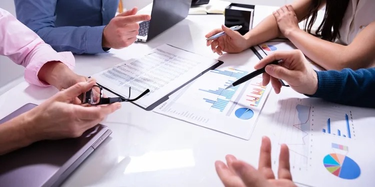 Corporate team discussing M&A deal with bank executives