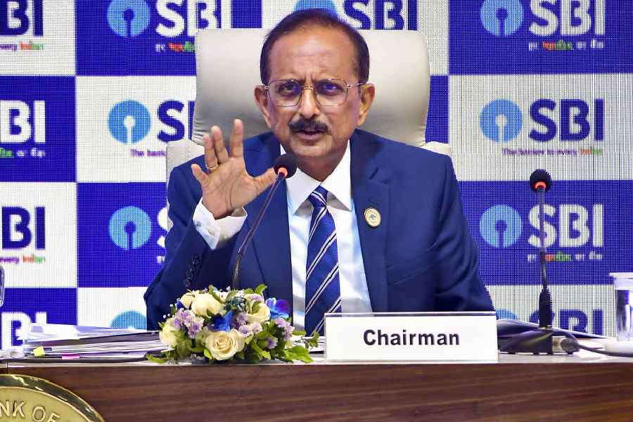 SBI Chairman addressing the media about economic growth, government demand push, and RBI liquidity measures.