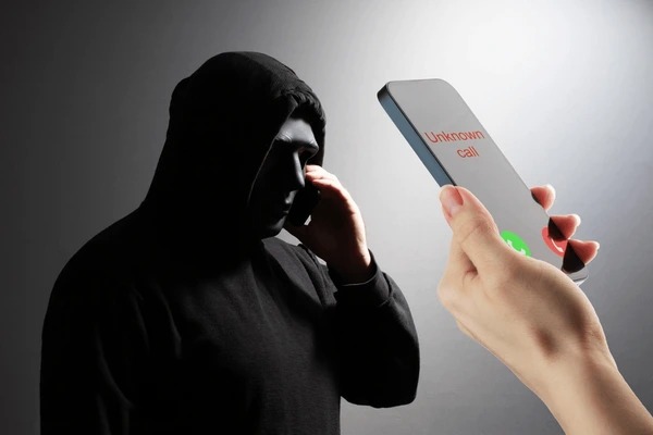 Person receiving a suspicious phone call asking for credit card details, highlighting phone scam risks.
