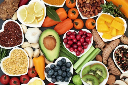 A colorful assortment of superfoods like berries, spinach, nuts, and seeds.