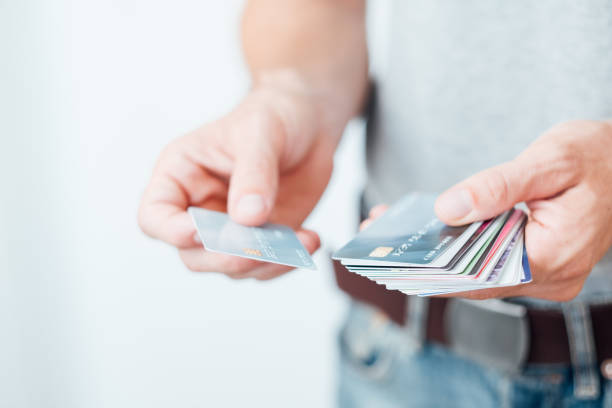 Man holding two credit cards comparing benefits