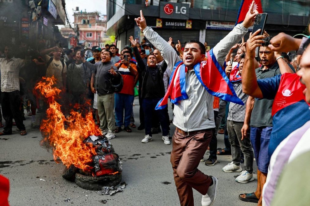 Nepalese protesters storming the Parliament during 2025 Gen Z-led uprising demanding government accountability.