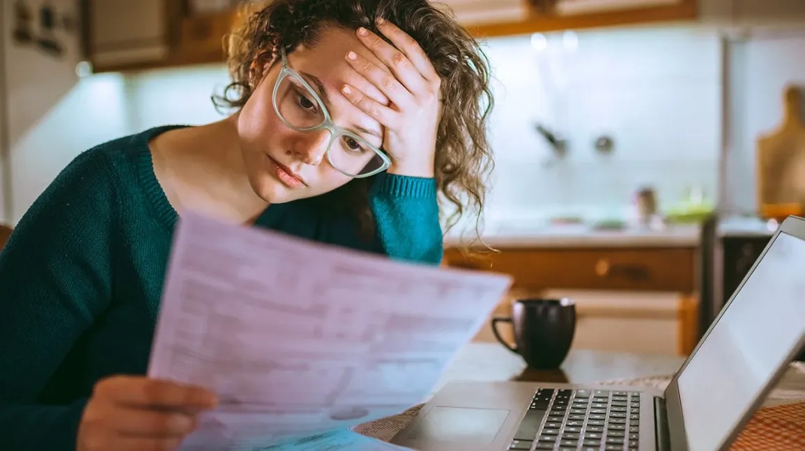 Person stressed with multiple loan statements