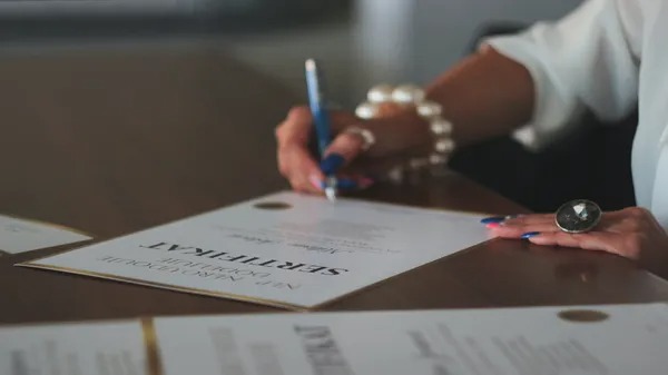 Person signing loan documents with another person