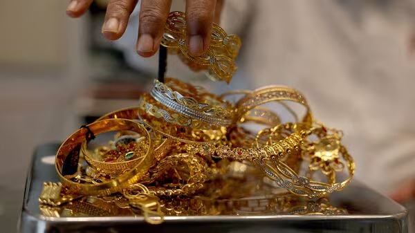 Customer pledging gold ornaments to avail a collateral-backed gold loan in India