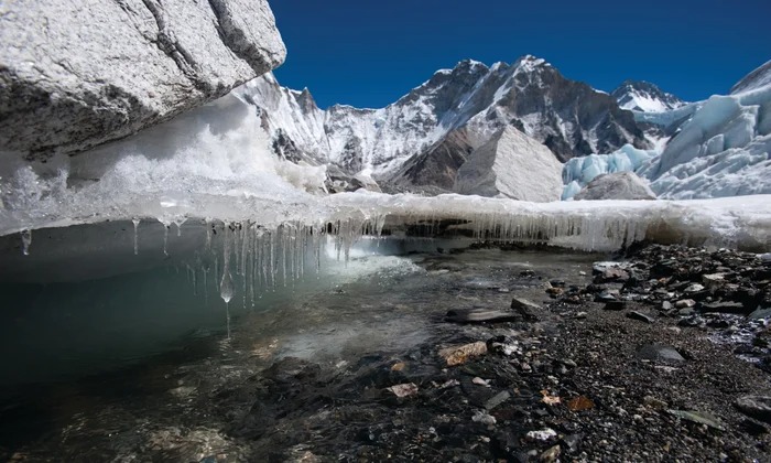 Himalayan mountains with melting glaciers and storm clouds indicating climate change effects
